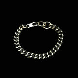 A silver wrist chain with a classic round edge curb chain design, displayed against a black background.